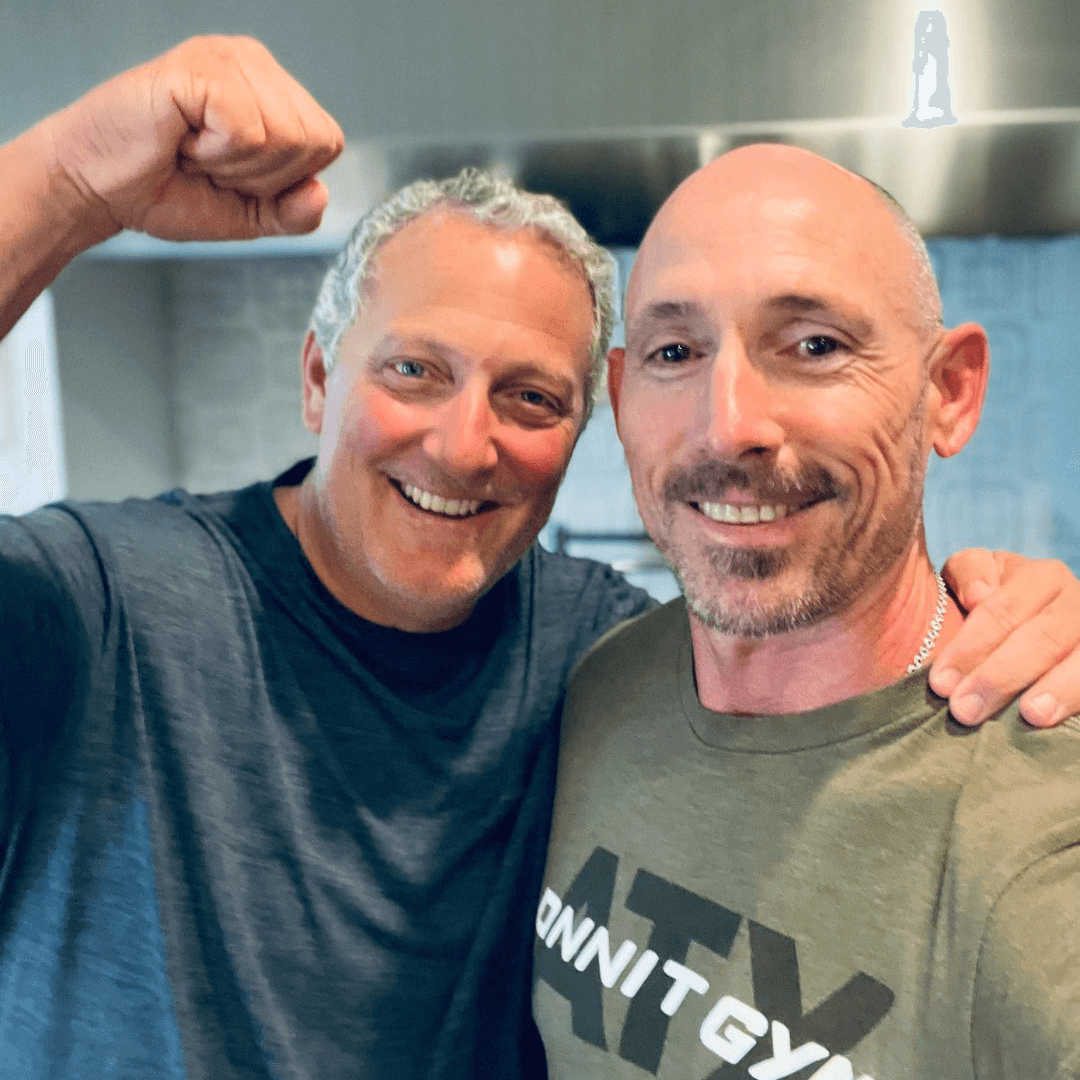 OrthoHeaven Two men stand close together indoors, smiling at the camera. One has his arm around the other's shoulder and is holding his fist up in a celebratory gesture, proudly showing off their OrthoHeaven achievements. Freedom Mapping