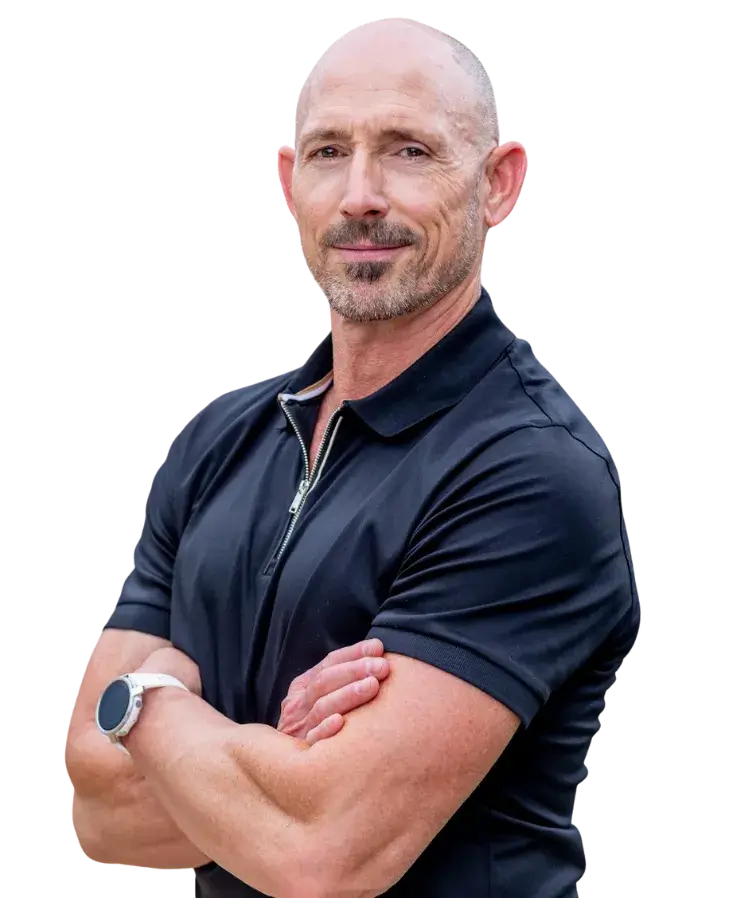 OrthoHeaven Bald man with a goatee wearing a black short-sleeve polo shirt and a white smartwatch stands with arms crossed, looking at the camera—ready to represent OrthoHeaven. Freedom Mapping