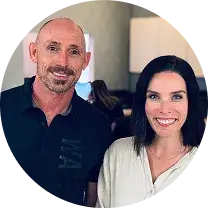 OrthoHeaven A man and a woman stand side by side indoors, both smiling at the camera, showcasing their bright smiles after visiting OrthoHeaven. Freedom Mapping