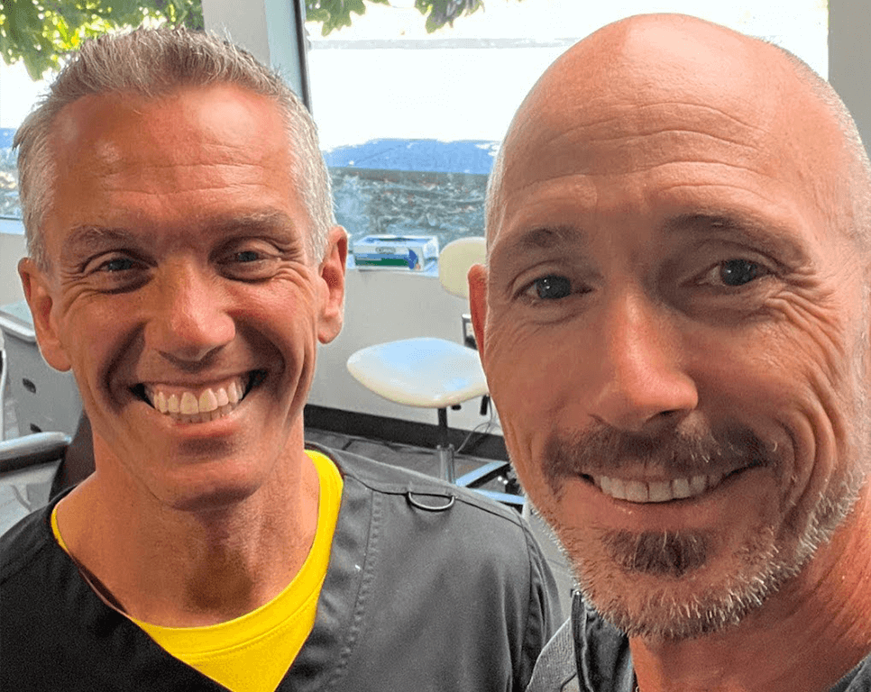 OrthoHeaven Two smiling men stand indoors at OrthoHeaven, with a window and chairs in the background. Freedom Mapping