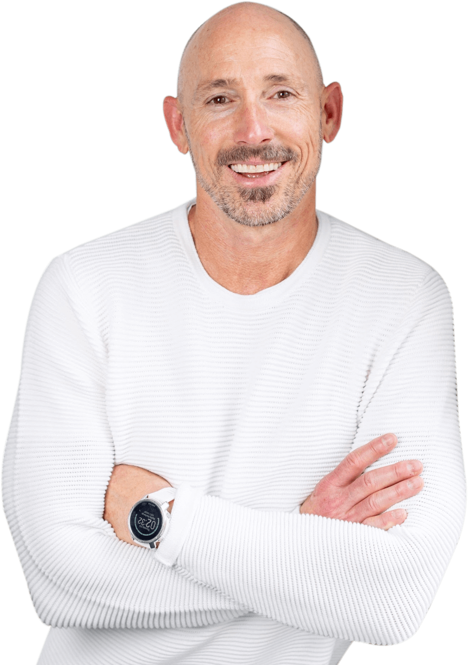 OrthoHeaven Bald man with a beard and mustache wearing a white textured sweater and a smartwatch, standing with arms crossed and smiling—capturing the confident spirit of OrthoHeaven. Freedom Mapping
