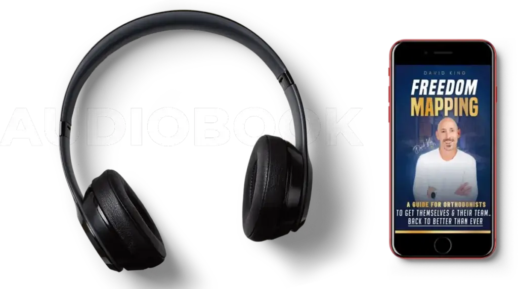 OrthoHeaven Black headphones and a smartphone with an audiobook cover titled "Freedom Mapping" by David King, displayed on a black background with the word "AUDIOBOOK" in bold white letters. Freedom Mapping
